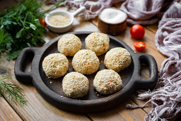 Cheese snack: balls of cheese, olives, and sesame seeds. Cheese balls for breakfast. Delicious snacks for lunch. Close-up