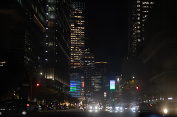 Shibuya Cityscape at Night with Illuminated Skyscrapers and Traffic Lights