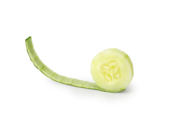 Close-up of a fresh cucumber slice on a white background. Partially peeled skin creates a curving...