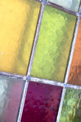 Close up abstract square stained glass window sections multicoloured background