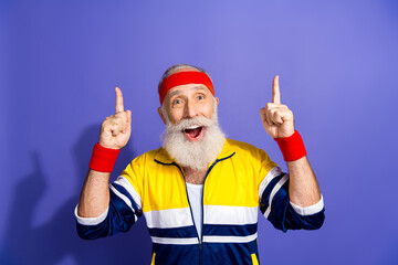 Active man with vibrant retro sportswear enthusiastically gesturing against a purple background in...