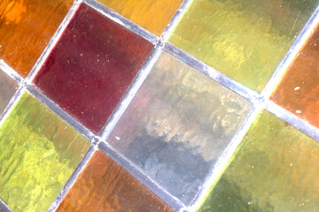 Close up abstract square stained glass window sections multicoloured background