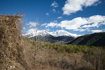 Snow-covered mountains rise quietly over rural Peloponnese 