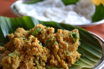 A platter of crispy fried tempura shrimp or fried cauliflower with a dipping sauce.