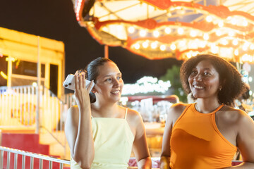 Two friends enjoying a night at the carnival
