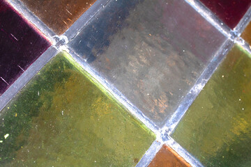 Close up abstract square stained glass window sections multicoloured background