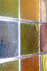 Close up abstract square stained glass window sections multicoloured background