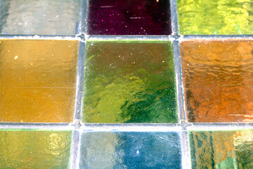 Close up abstract square stained glass window sections multicoloured background