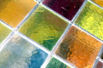 Close up abstract square stained glass window sections multicoloured background