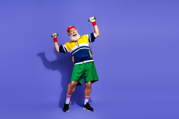 Sportive athlete enjoying fitness training in retro inspired sportswear on colorful background