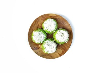 Putu Cake on a wooden plate, Indonesian traditional cake made from rice flour and filled sugar palm. Flat lay 
