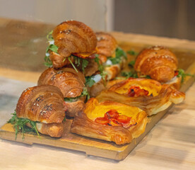 Italian Croissants Sandwich and Danish Sweet Pastry at Wooden Tray for Breakfast