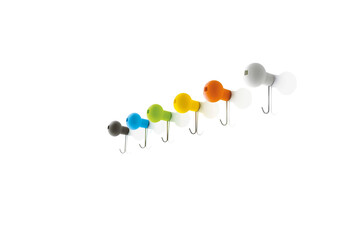 Color towel hooks in a row isolated on white