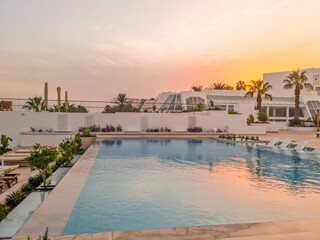 Sunset in a swimming pool by the sea