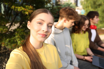 Teenagers spending time together in park, selective focus