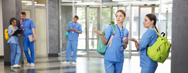 Medical students in uniforms indoors, selective focus