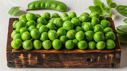 Fresh peas in wooden box on white background with pea pods