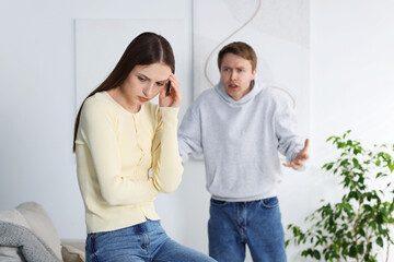 Woman and man having fight at home, selective focus