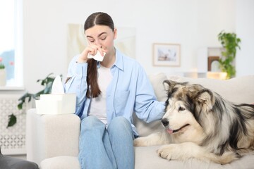 Woman suffering from allergy with her dog at home