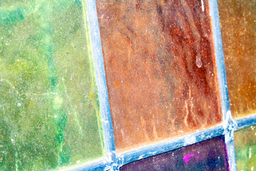 Close up abstract square stained glass window sections multicoloured background