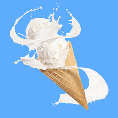 Tasty ice cream in waffle cone and milk splash against light blue background