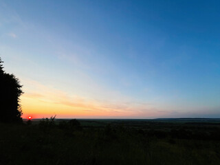 Colorful sunset over scenic countryside with vibrant sky and peaceful landscape