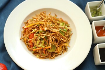 Noodles or chowmein with vegetables in a bowl in a restaurant or cafe