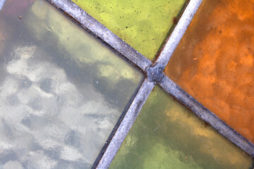 Close up abstract square stained glass window sections multicoloured background
