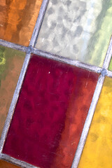 Close up abstract square stained glass window sections multicoloured background
