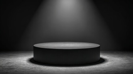 A dark stage with a round, empty pedestal illuminated by a single spotlight, creating a dramatic and focused atmosphere.