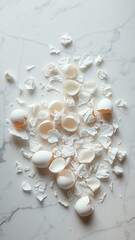 Fototapeta premium Eggshell Fragments Spread on a White Surface