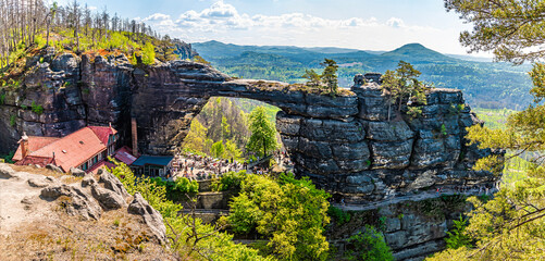 Fototapeta premium A view past trees towards the Pravcicka Gate arch in springtime