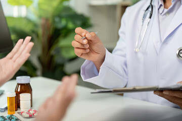 Medication Discussion. Doctor explaining prescription to patient during consultation.