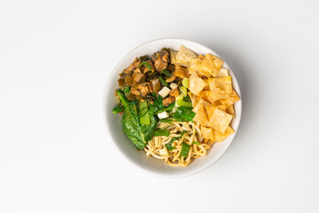 Delicious Asian Chicken Noodle Bowl with Green Vegetables and Crispy Wontons on White Background, Top View