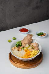 Indonesian Bakso: Savory Meatball Soup with Noodles, Crispy Wonton, and Fresh Toppings. Traditional Asian Cuisine.