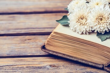 Old Book with Pressed Chrysanthemum Flowers on Wooden Background