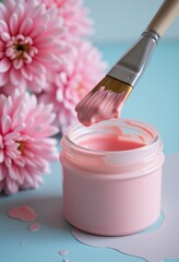 Pink paint dripping from a brush into an open jar with pastel pink flowers in the background