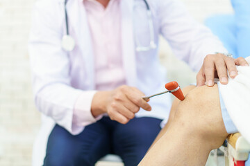 Orthopedic doctor checking on elderly woman knee.