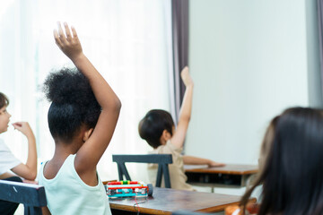 Young students enjoy learning a sciences in classroom.