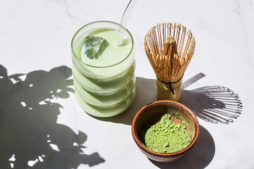 Iced Matcha Refreshment. Refreshing iced matcha drinks with a bamboo whisk and matcha powder