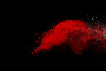 Red powder explosion on black background. Colored cloud. Colorful dust explode. Paint Holi	
