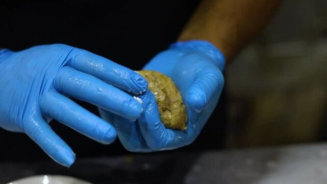 Meatballs being prepared in a kitchen of a restaurant