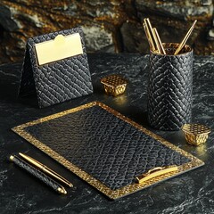 Elegant Black Slate Surface with Gold Accents and Stylish Office Accessories