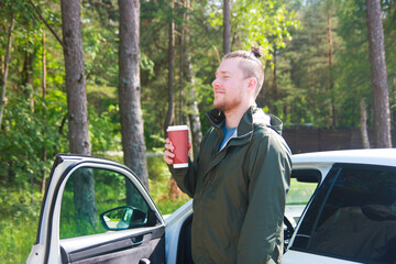 Man in Sports Jacket Enjoying Morning Coffee Outdoors by Car in Nature