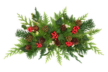 Festive Christmas decoration with natural flora of holly, mistletoe berries, ivy, fir, pine cones....