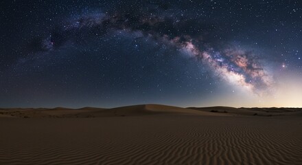 Fototapeta premium Milky Way's ethereal glow over rippled desert dunes, a serene night landscape