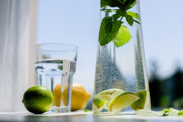 Homemade citrus refreshing summer lemonade drink with lemon, lime and mint in mason jars. Taste of...