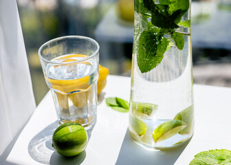 Homemade citrus refreshing summer lemonade drink with lemon, lime and mint in mason jars. Taste of summer.  Drinking in the heat