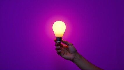 Hand Holding Glowing Light Bulb on Vibrant Purple Background – Creative Idea Concept

