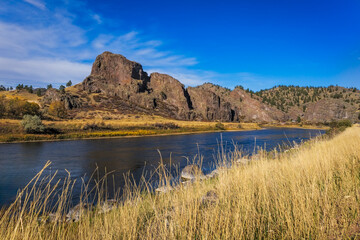 Missouri River flowing through Montana landscape with cliffs and dry grass
